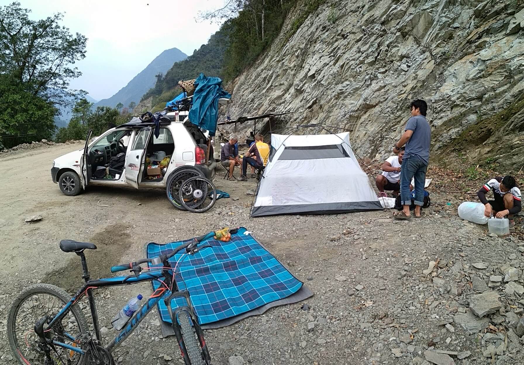 Crew and travellers parked by the road during a landslide