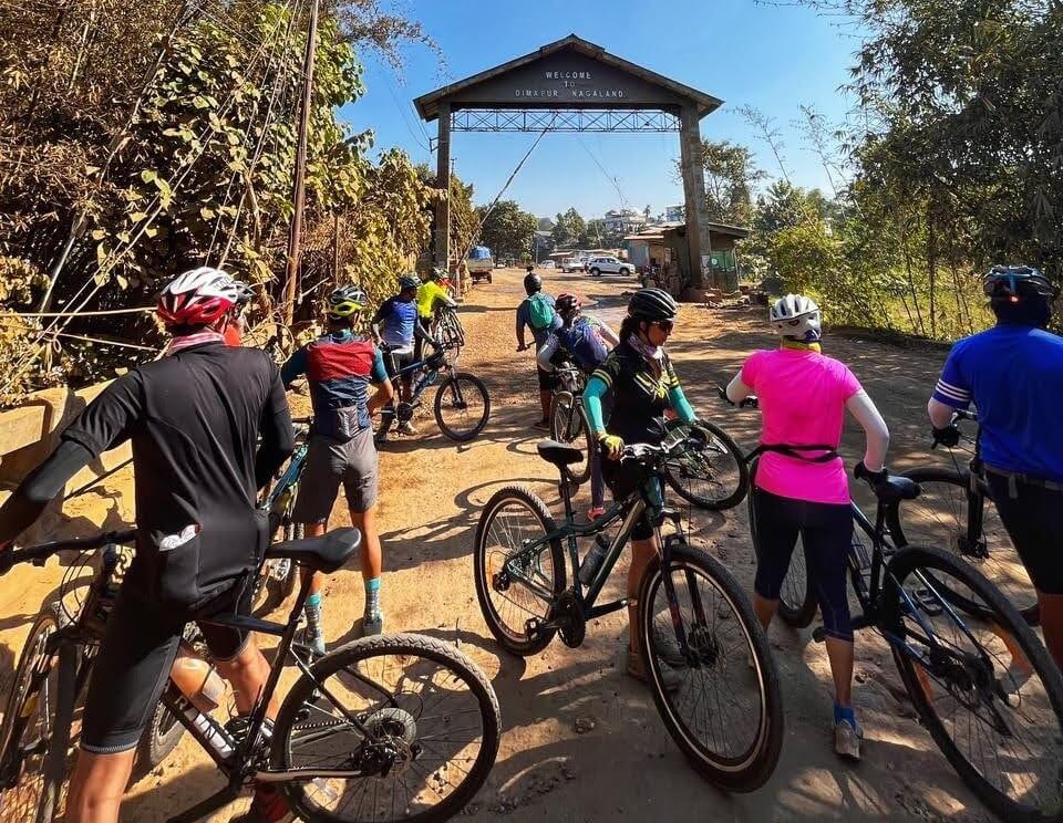 Ten cyclists on a tour parked beyond the Nagaland border 